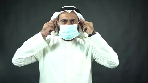 Arab businessman with beard put on face mask sadly Stock Footage 134373993