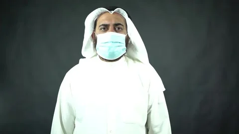 Arab businessman with face mask checking time and waiting Stock Footage 134374001
