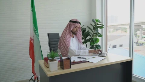 Arab businessman sitting at the table working laptop and using mobile phone Video stock 120546031