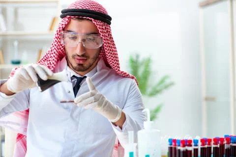 Arab chemist scientist testing quality of oil petrol Фото