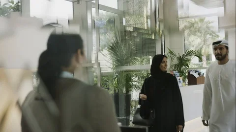 Arab couple approaching hotel concierge Stock Footage 105805189