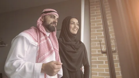 Arab couple looking throught window at home. Stock Footage 128763748