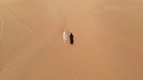 Arab couple walking in a desert Stock Footage 94462046