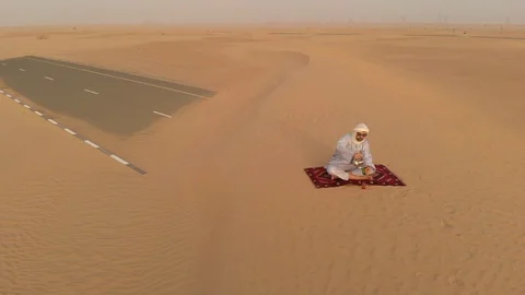 Arab in a desert drinking tea Stock Footage 94410396