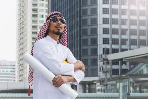 Arab Engineer construction worker holding blueprint Stock Photos