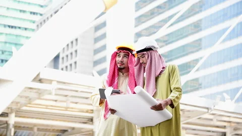 Arab engineer consult construction project together hold blueprint, pointing at  Stock Footage 137630775
