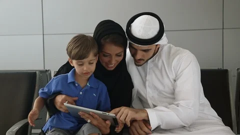 Arab family using digital tablet in departure lounge. Stock Footage 101719749