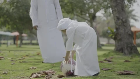 Arab father and son playing football in the park. Stock Footage 303636148