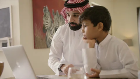 Arab father and son working at home. Stock Footage 135644236