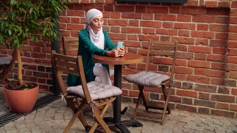 Arab female and technologies concept.. Young muslim woman talking on video call Stock Footage 250417133