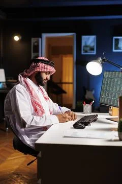 Arab guy taking notes and surfs the net 스톡 사진
