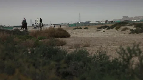 Arab Horsemen in Bahrain. Wide angle with desert context. Stock Footage 59591815