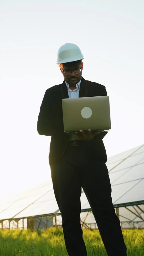 Arab investor using laptop in solar panel farm Stock Footage 314410835