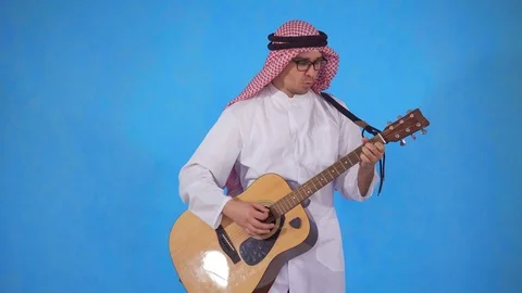Arab man with an acoustic guitar Stock Footage 106989274
