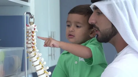 Arab man and boy looking at skeleton in hospital. Stock Footage 70098174