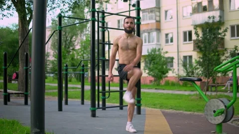 The Arab man with a beard stretches and warms up before running. Stock Footage 200844986