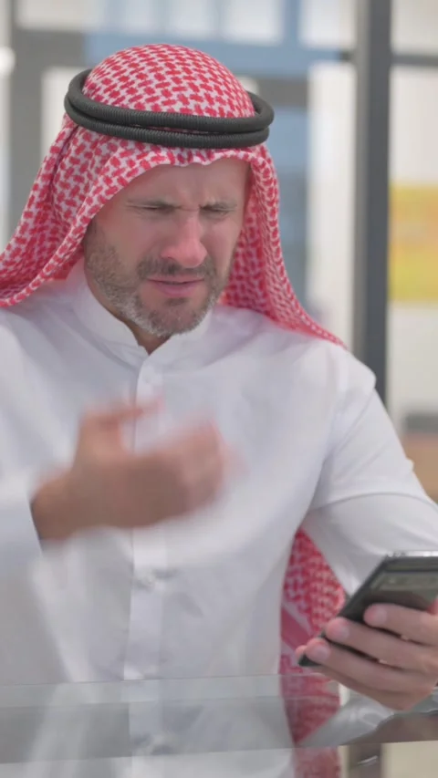 Arab Man Browsing Internet on Phone in Office, vertical video Video stock 324707846