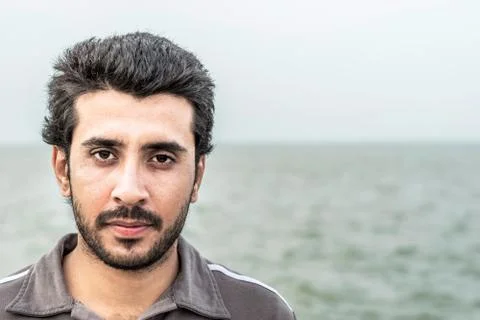 Arab man having beard and wearing western clothes and feeling happy Stock Photos