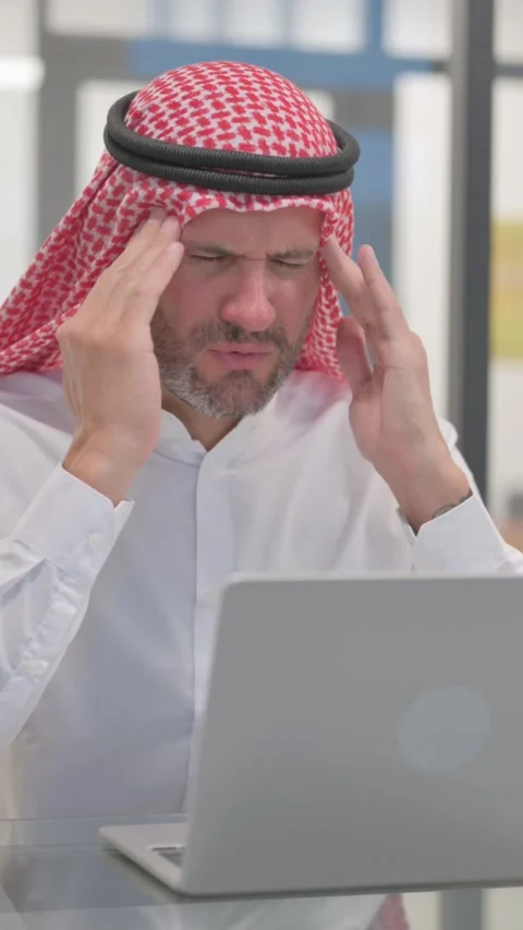 Arab Man having Headache at Work, vertical video Video stock 324777222