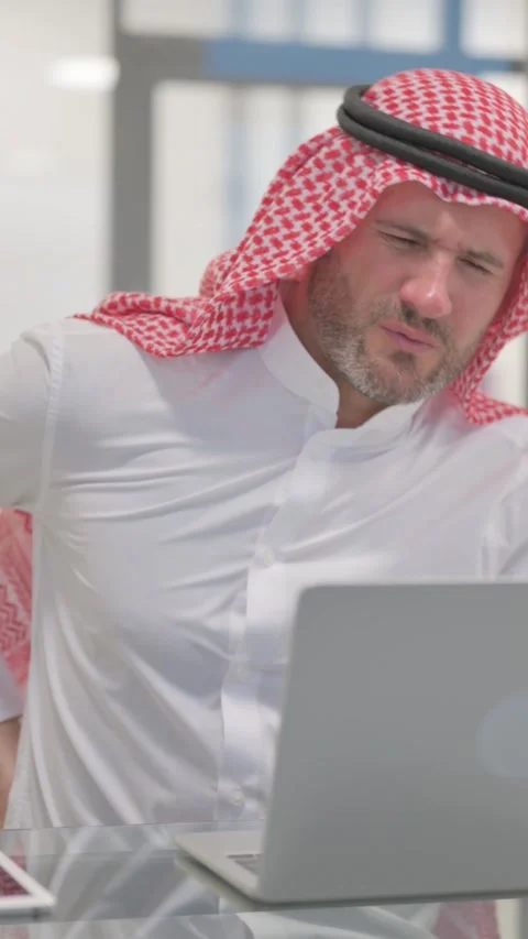 Arab Man having Spinal Spasm at Work, vertical video Stock Footage 324777226