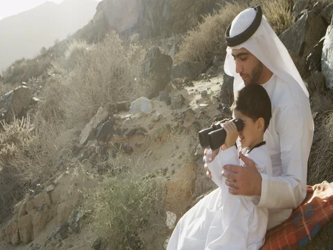 Arab man with his son looking through binoculars. Stock Footage 69449962