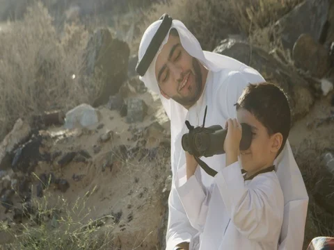Arab man with his son looking through binoculars. Stock Footage 69455938