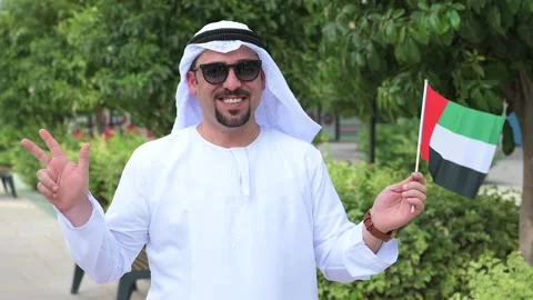 Arab Man holding UAE flags Video stock 142236949