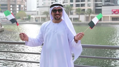 Arab Man holding UAE flags Video stock 142237151