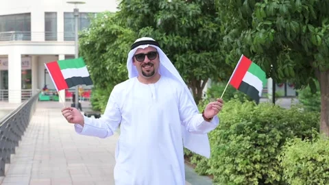 Arab Man holding UAE flags Video stock 142237188