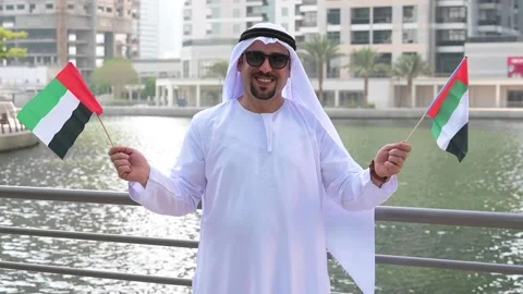 Arab Man holding UAE flags Video stock 142237194