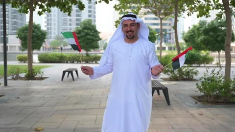 Arab Man holding UAE flags Video stock 142237207