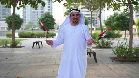 Arab Man holding UAE flags Video stock 142237209