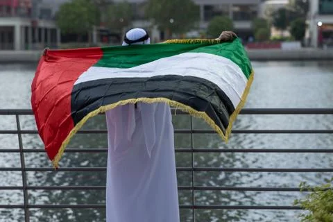 Arab man holding the UAE National Flag Stock Photos