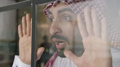 Arab man looking out the window. Video stock 152978058
