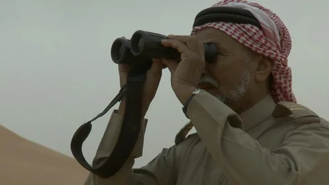 An Arab man looking through his binoculars. Stock Footage 120063807