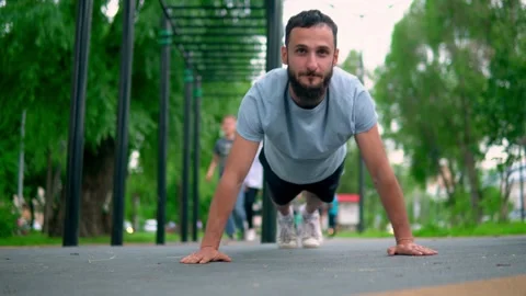 The Arab man performs exercises compressed from the floor in the street Stock Footage 199427450