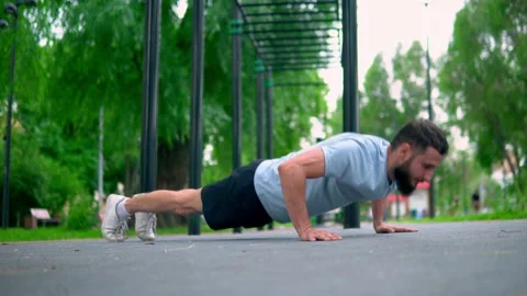 The Arab man performs exercises compressed from the floor in the street Stock Footage 199427500