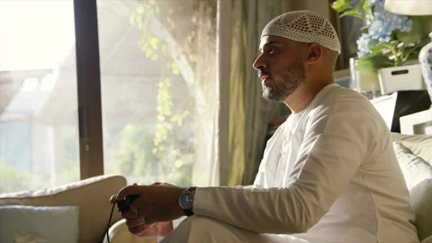 Arab man playing video game. Stock Footage 136063298