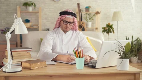 Arab man sitting at table with headache Stock Footage 106143143