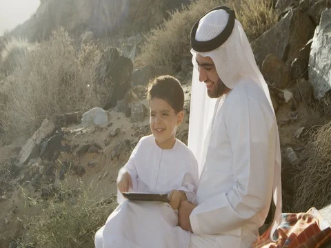 Arab man with son holding digital tablet. Stock Footage 69458433