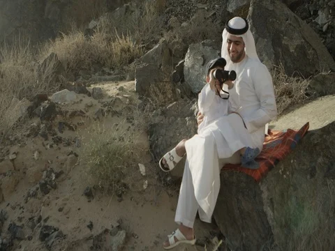 Arab man with son looking through binoculars. Stock Footage 69463459