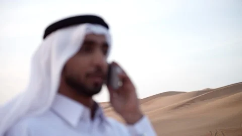 Arab man talking on mobile at desert. Stock Footage 119394301