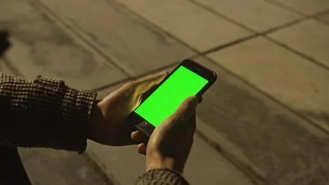 Arab man using Chroma Key Smartphone while Walking Through Night City Street. Stock Footage 157320207