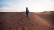 Arab Man Walking In The Desert Sand Cinemagraph Stock Footage