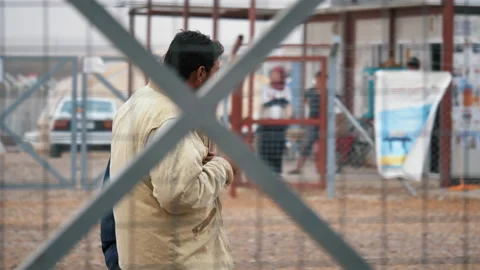 Arab man walks through the refugee camp. November 9, 2017, Mosul, Iraq. Stock Footage 158377199