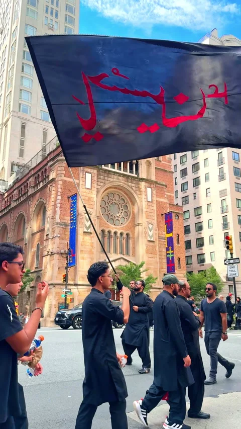 Arab man wearing black clothes and sunglasses stands outdoors waving a flag with Stock Footage 327405811