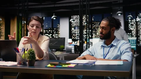 Arab man in wheelchair collaborating with woman in modern office Stock Footage 334040711