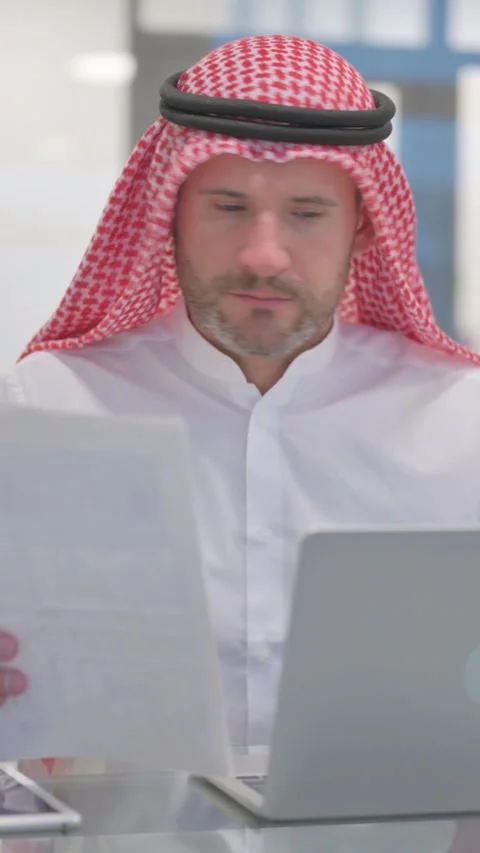 Arab Man Working on Documents in Office, vertical video Stock Footage 324777256