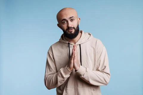 Arab manpleading with folded hands Stock Photos