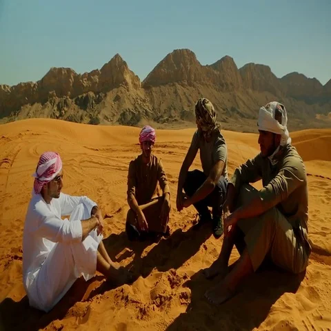 Arab men looking at quad biker on desert. Stock Footage 69482103